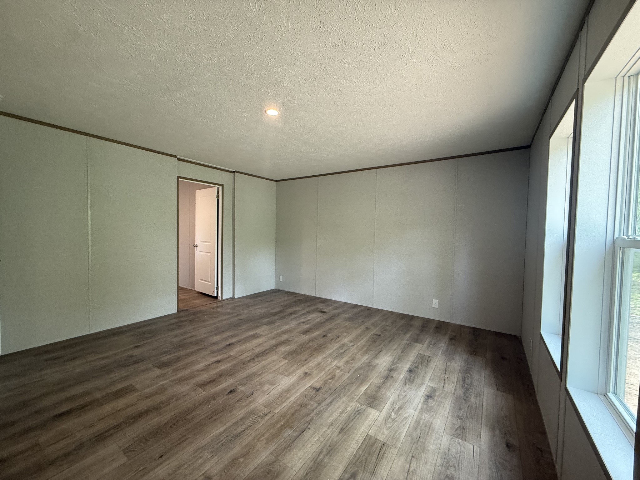 467 Woodland Road Hohenwald, TN 38462 - Photo 9 of 20 wooden floor in an empty room with a window