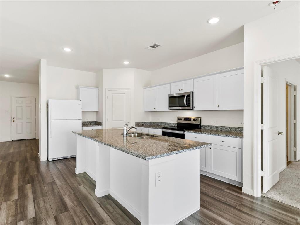13344 Ridings Drive Fort Worth, TX 76052 - Photo 15 of 29 a kitchen with white cabinets sink and stainless steel appliances