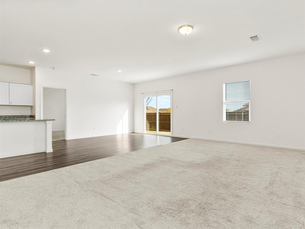 13344 Ridings Drive Fort Worth, TX 76052 - Photo 18 of 29 a view of an empty room with wooden floor and a window