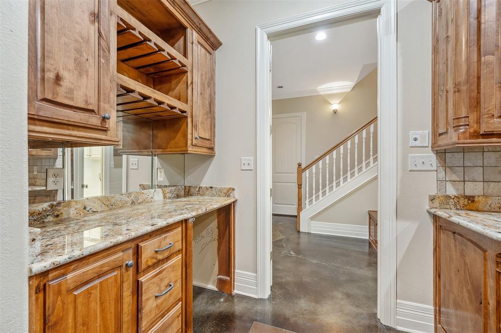 20389 County Road 178 Flint, TX 75762 - Photo 6 of 40 Wet bar featuring wood cabinetry, granite countertops, and a mirrored backsplash
