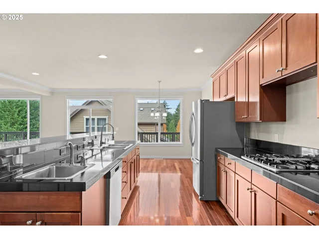 a kitchen with granite countertop a sink and cabinets