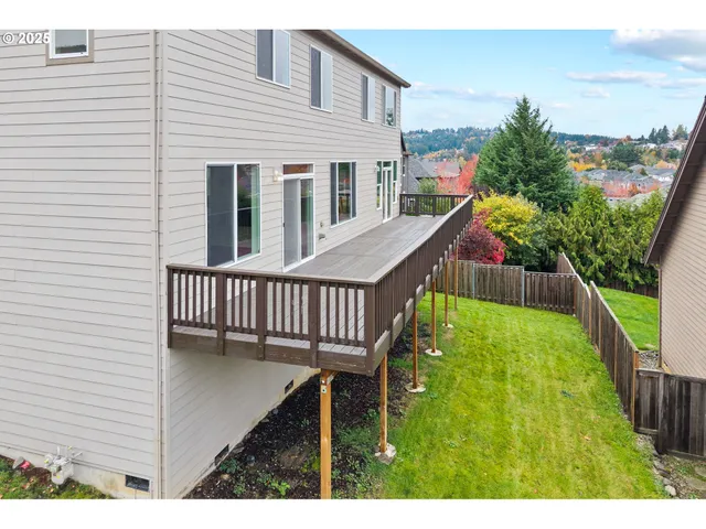 a living room with furniture a flat screen tv and a large window