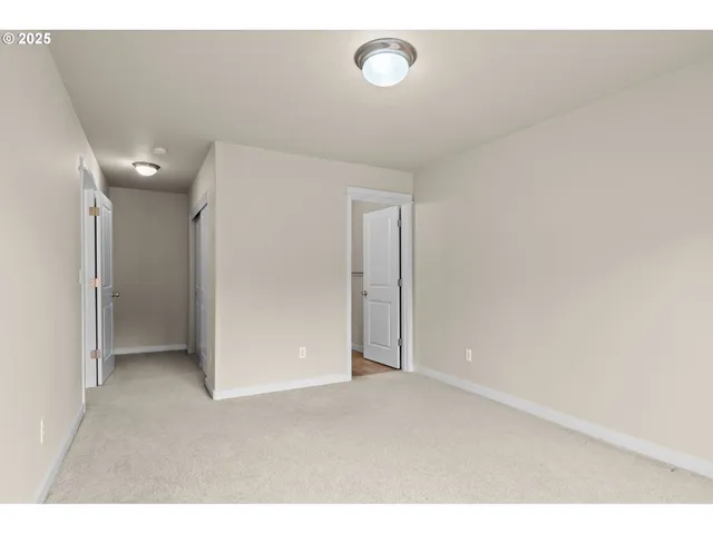 a spacious bedroom with a bed and a large window