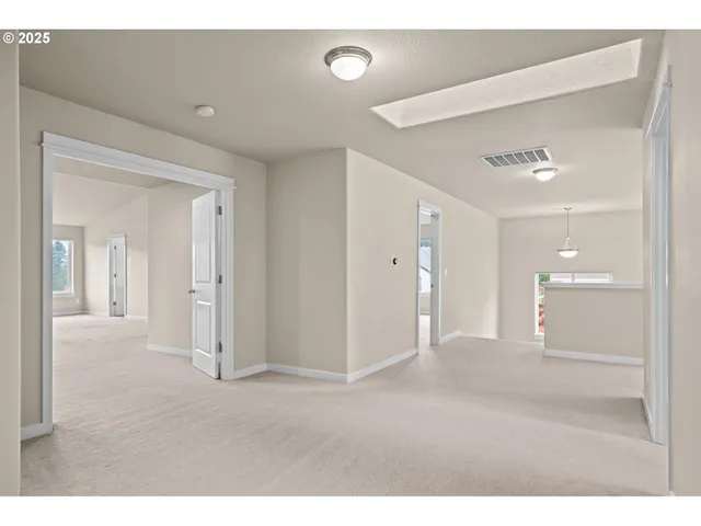 a spacious bedroom with a bed and window