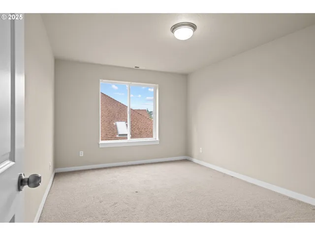 a view of empty room with a fireplace