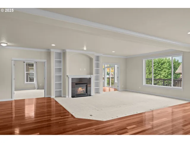 a view of empty room with fireplace and window