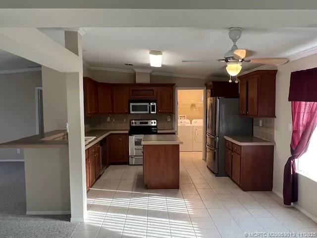 a kitchen with a sink stove top oven and wooden cabinets