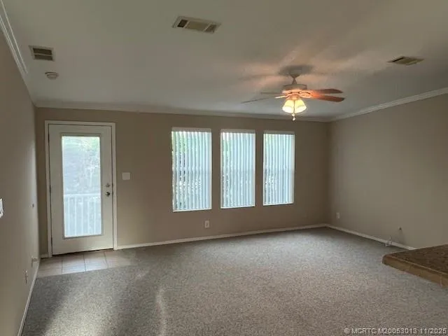 an empty room with windows and entrance