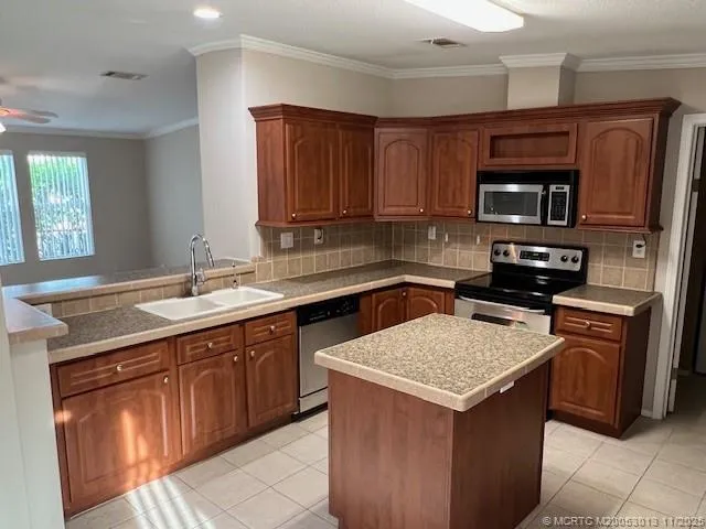 a kitchen with stainless steel appliances and cabinets