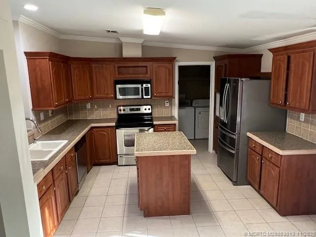 a view of a hallway to a big room with wooden floor and stairs