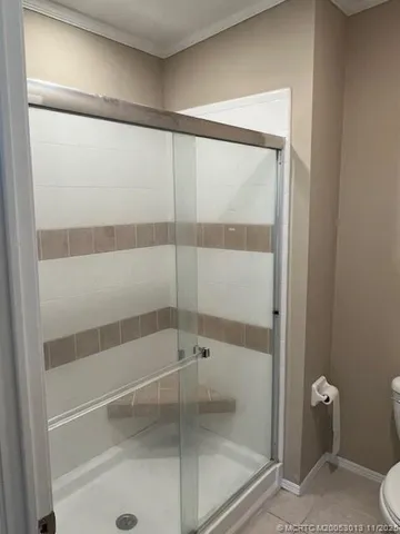 a bathroom with a toilet and a shower