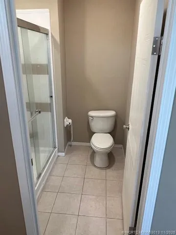 a bathroom with a glass shower door