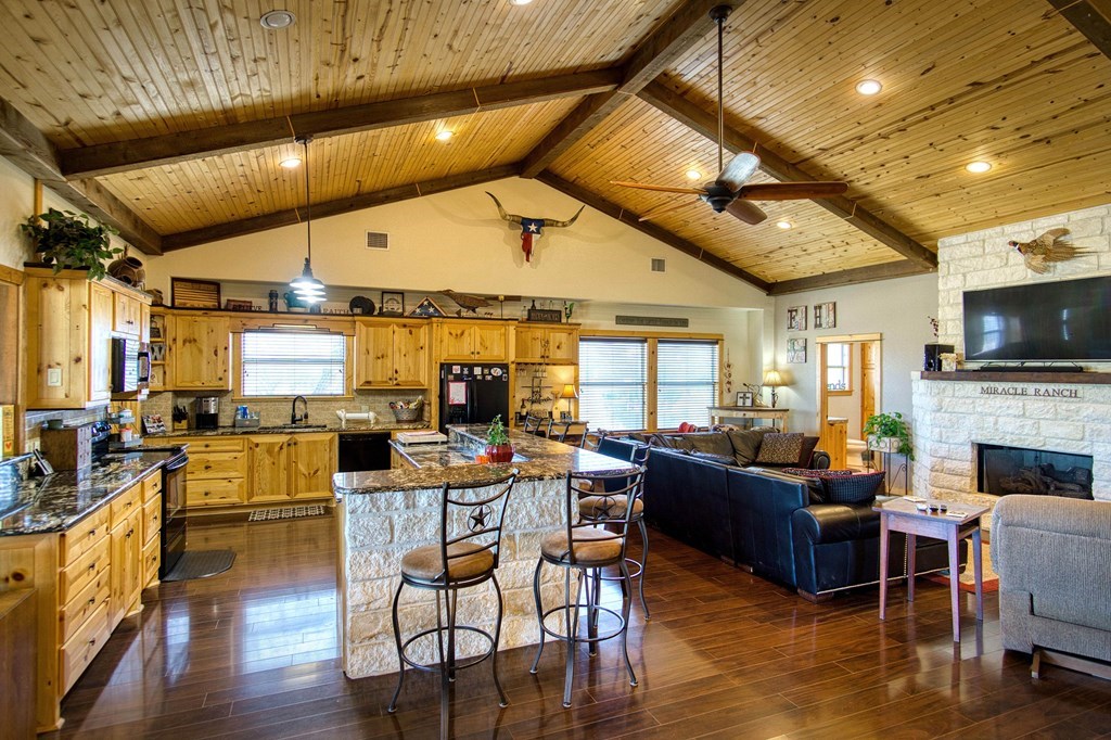 6446 Blackjack Road Fredonia, TX 76842 - Photo 16 of 48 a living room with fireplace furniture and a large window