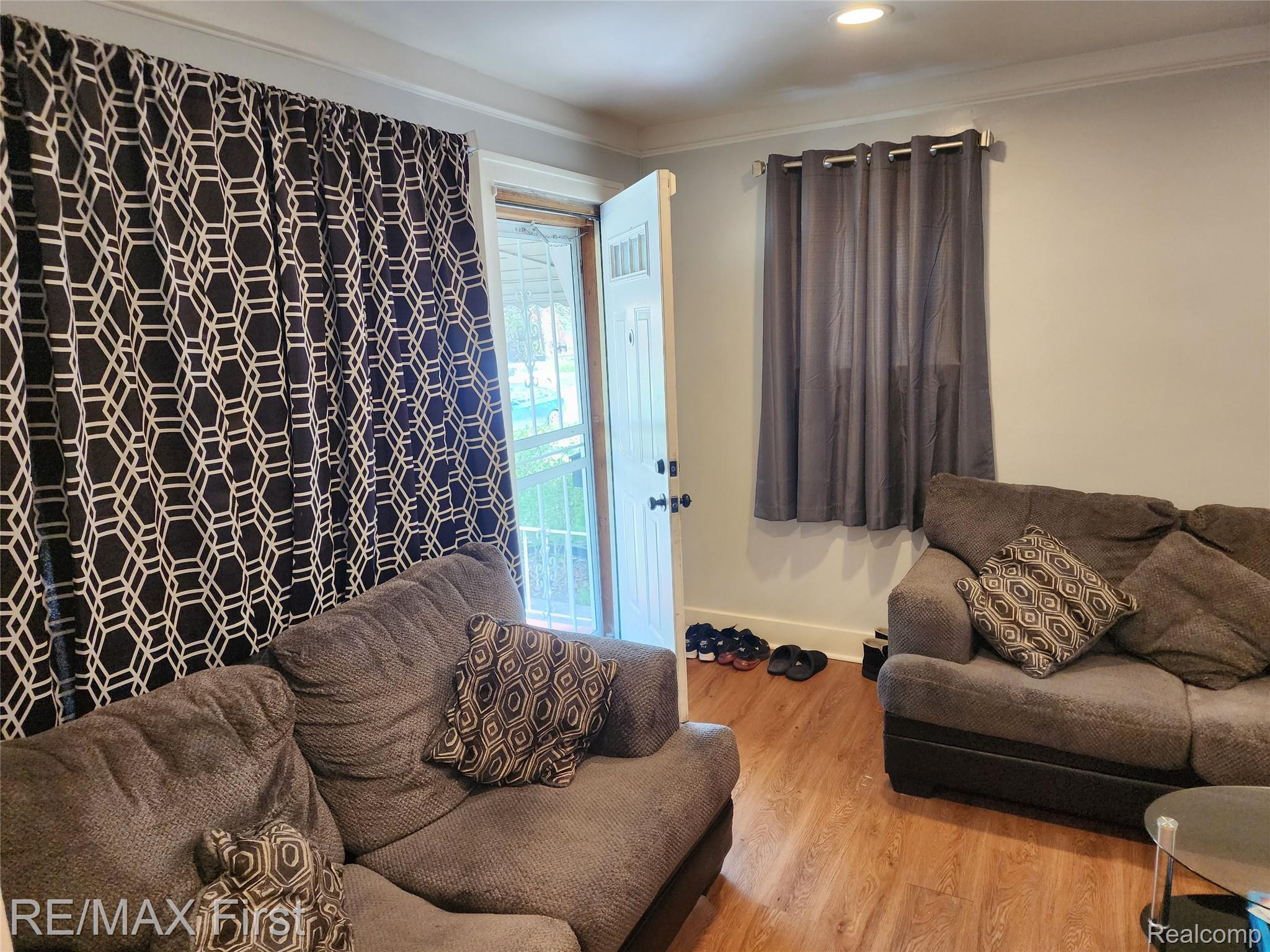 19345 Keystone Street Detroit, MI 48234 - Photo 4 of 15 Living room with wood finished floors and crown molding