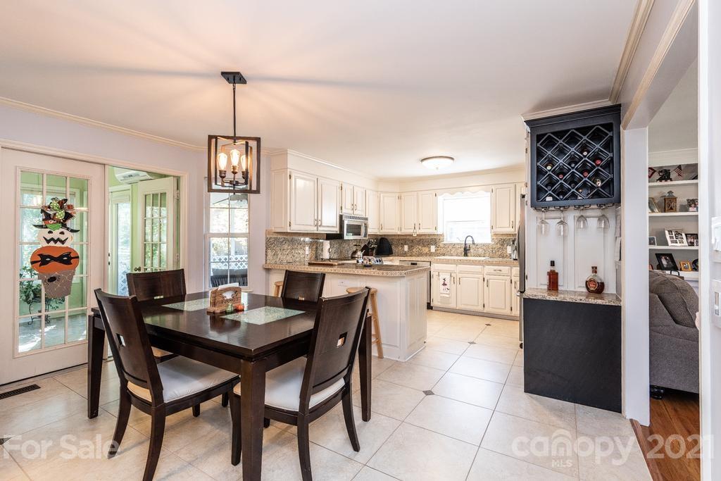 1002 4th Street Northeast Conover, NC 28613 - Photo 14 of 41 a kitchen with a dining table chairs and cabinets