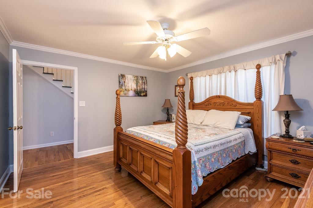 1002 4th Street Northeast Conover, NC 28613 - Photo 20 of 41 a bedroom with a bed and a chandelier