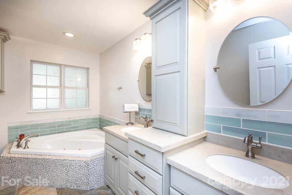 1002 4th Street Northeast Conover, NC 28613 - Photo 22 of 41 a bathroom with a granite countertop tub sink and mirror