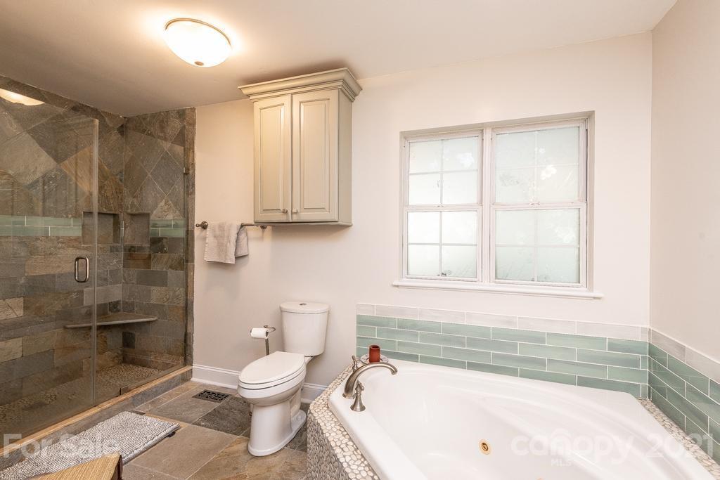 1002 4th Street Northeast Conover, NC 28613 - Photo 23 of 41 a bathroom with a toilet a sink and bathtub