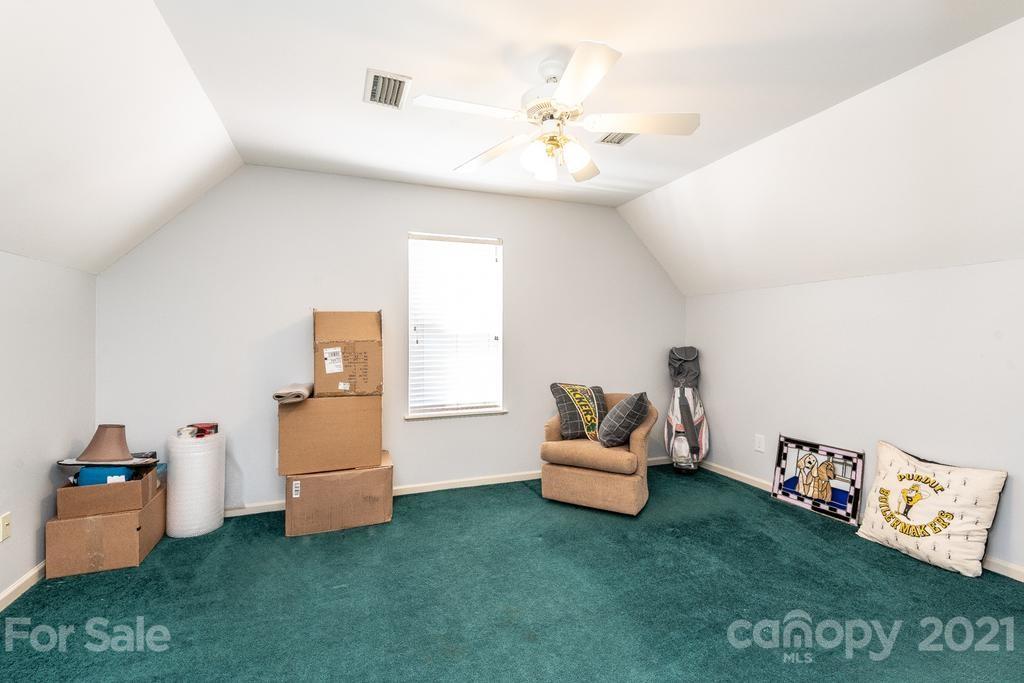 1002 4th Street Northeast Conover, NC 28613 - Photo 27 of 41 a living room with furniture and a baby crib