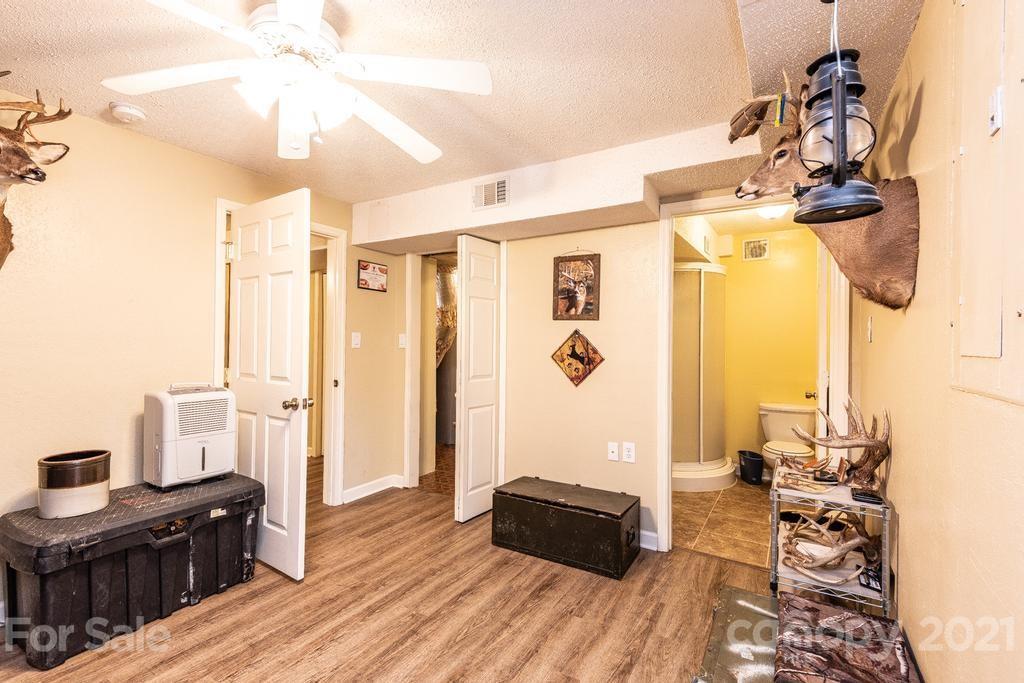 1002 4th Street Northeast Conover, NC 28613 - Photo 32 of 41 a view of a livingroom with furniture wooden floor and a chandelier