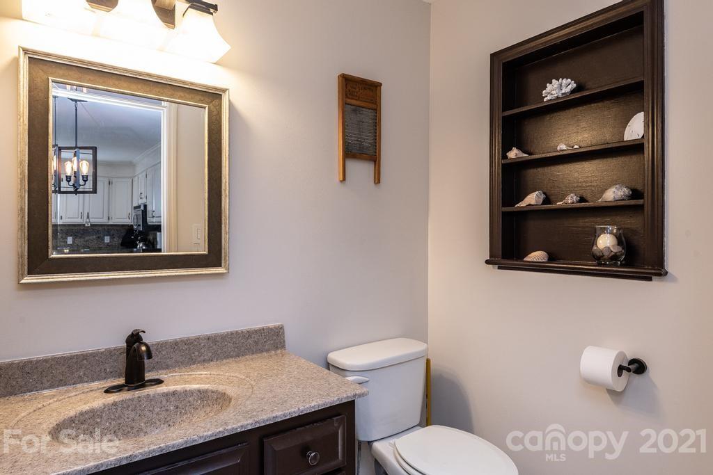 1002 4th Street Northeast Conover, NC 28613 - Photo 34 of 41 a bathroom with a granite countertop sink and a mirror