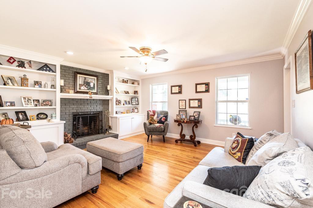 1002 4th Street Northeast Conover, NC 28613 - Photo 9 of 41 a living room with furniture fireplace and a window