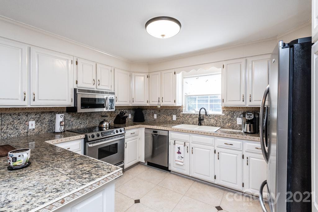 1002 4th Street Northeast Conover, NC 28613 - Photo 10 of 41 a kitchen with cabinets appliances a sink and a counter top space