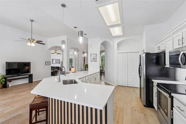 a kitchen with a sink a counter space and a fireplace