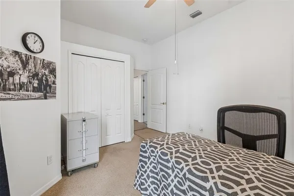 a view of a chair and table in backyard of the house