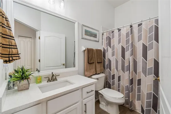 an aerial view of a city with lots of residential buildings and mountain view in back