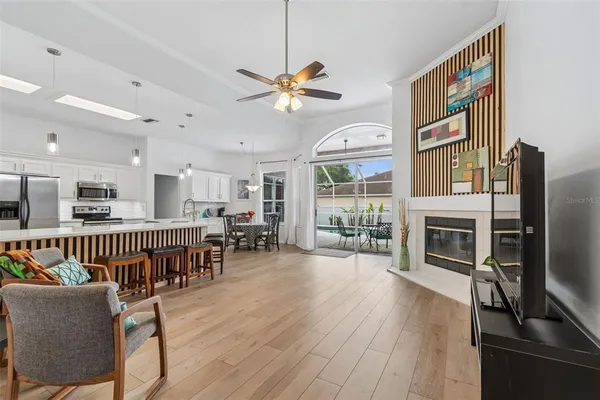 a living room with furniture a fireplace and a flat screen tv