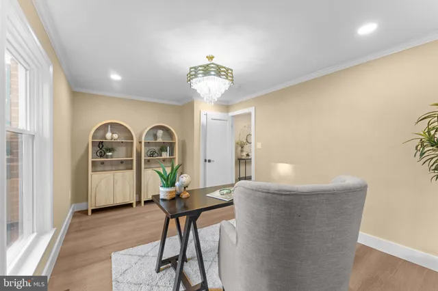 a living room with a sink and chandelier