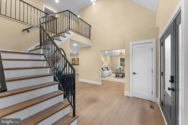 a view of entryway and hall with wooden floor