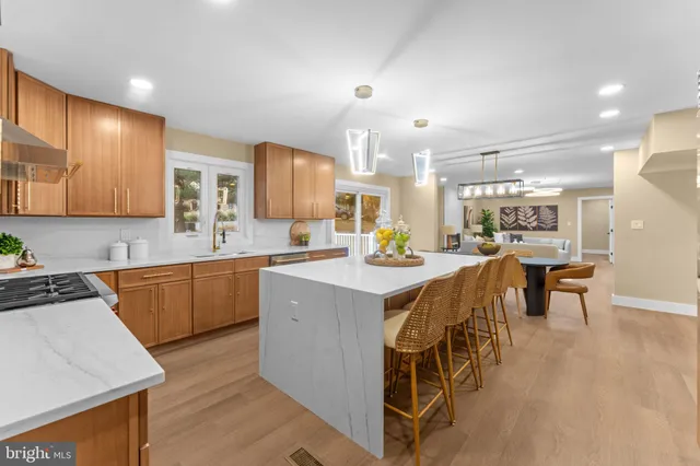 a kitchen with a sink cabinets and wooden floor