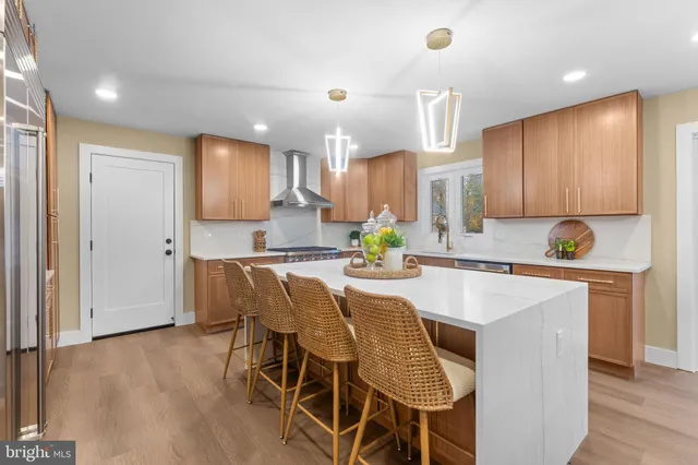 a kitchen with kitchen island granite countertop wooden cabinets and center island
