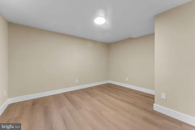 a view of a hallway with wooden floor and entryway