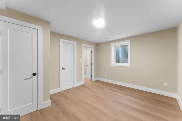 a bathroom with a sink a toilet and a large mirror