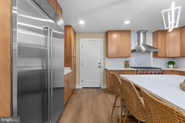 a kitchen with cabinets and wooden floor