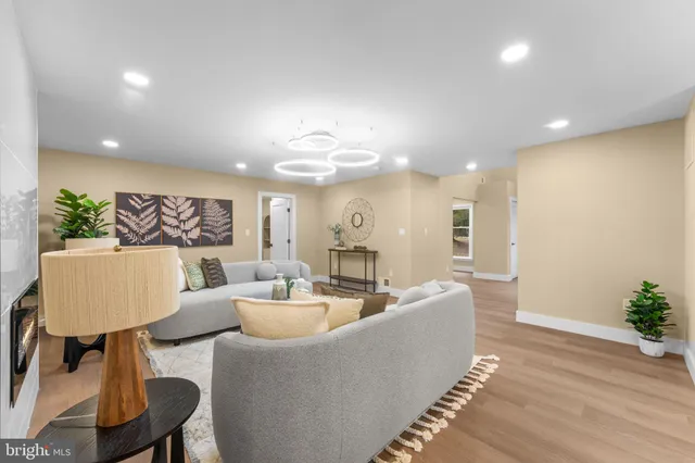 a living room with furniture and a chandelier