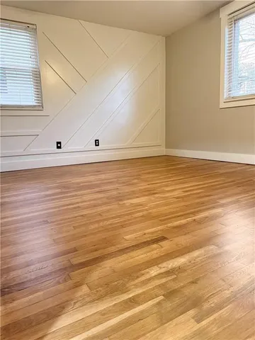 a view of a room with wooden floor