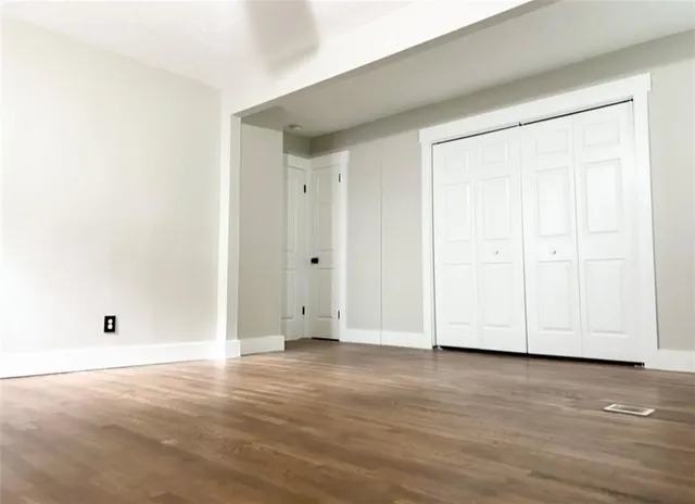 an empty room with wooden floor