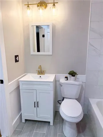 a bathroom with a sink toilet and mirror