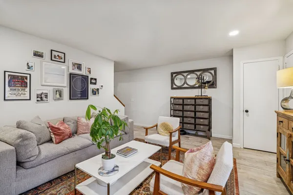 a living room with furniture a flat screen tv and a window