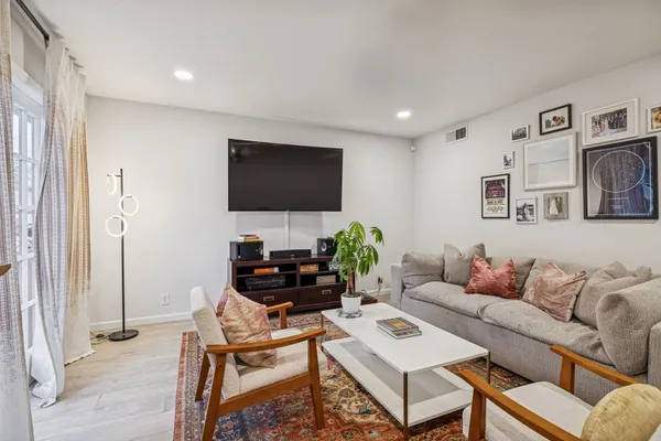 a living room with furniture and wooden floor