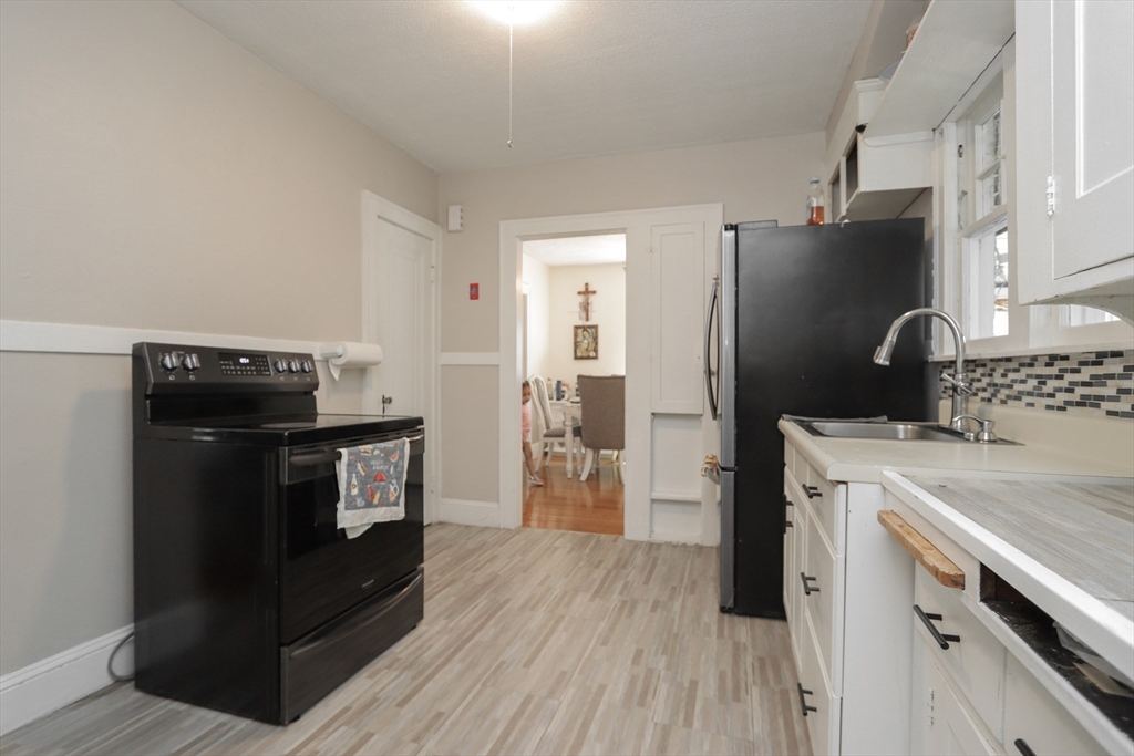 34 Preston Street Springfield, MA 01109 - Photo 14 of 34 a kitchen with a refrigerator stove and sink