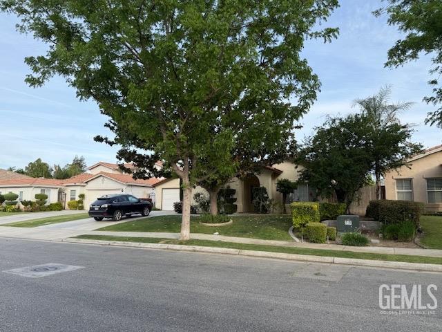 Undisclosed Address Bakersfield, CA 93311 - Photo 3 of 16 a white house with a tree in front of it