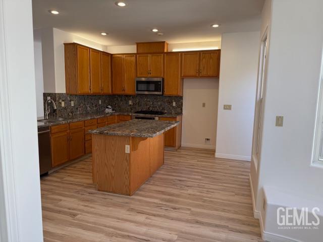 Undisclosed Address Bakersfield, CA 93311 - Photo 10 of 16 a large kitchen with stainless steel appliances granite countertop a stove a sink and a refrigerator