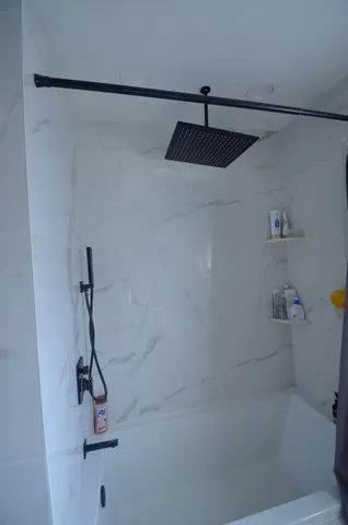 a bedroom with a bed and glass wall