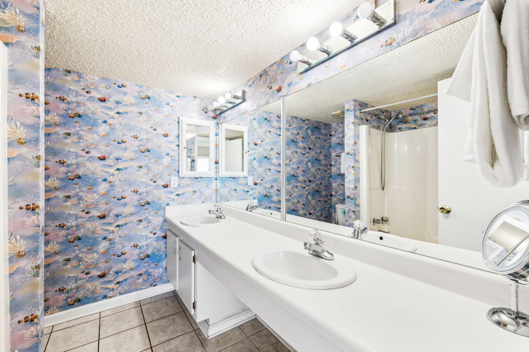 23223 Front Beach Road, Unit B2405 Panama City Beach, FL 32413 - Photo 13 of 28 a bathroom with a sink a vanity and a mirror