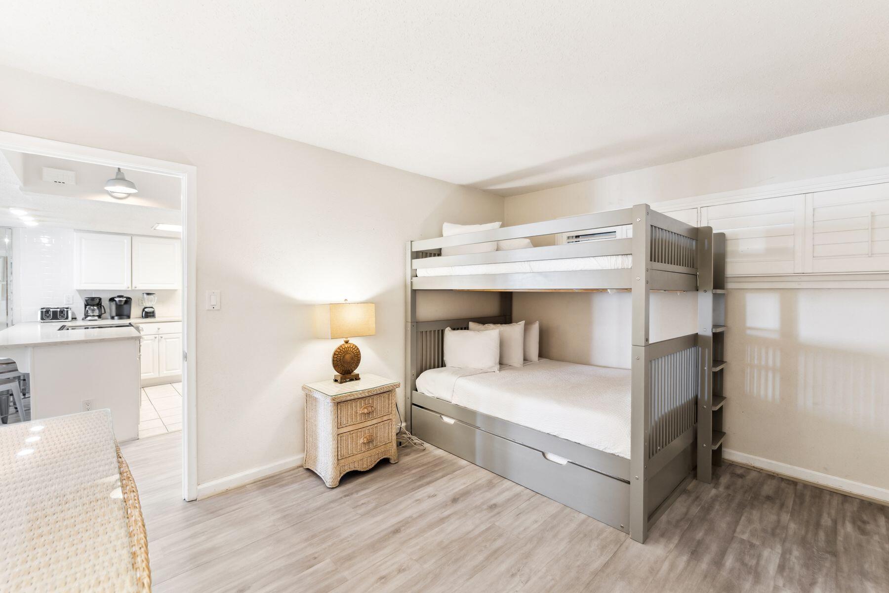 23223 Front Beach Road, Unit B2405 Panama City Beach, FL 32413 - Photo 15 of 28 a bedroom with a bed and a view of kitchen